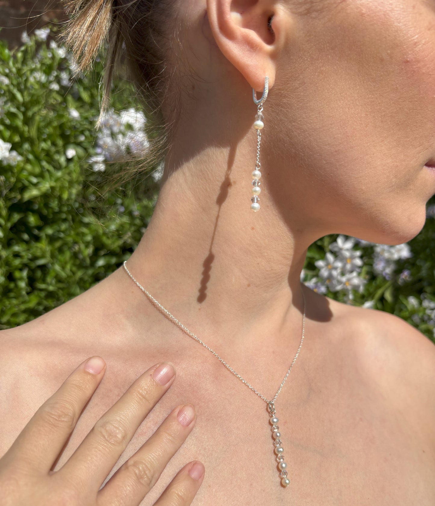Pearl and crystal earrings using 4mm freshwater pearls and highest quality crystals (also 4mm). The earrings are suspended from sterling silver hoops studded with tiny crystals to reflect the light. Shown worn with our pearl and crystal back drop necklace.