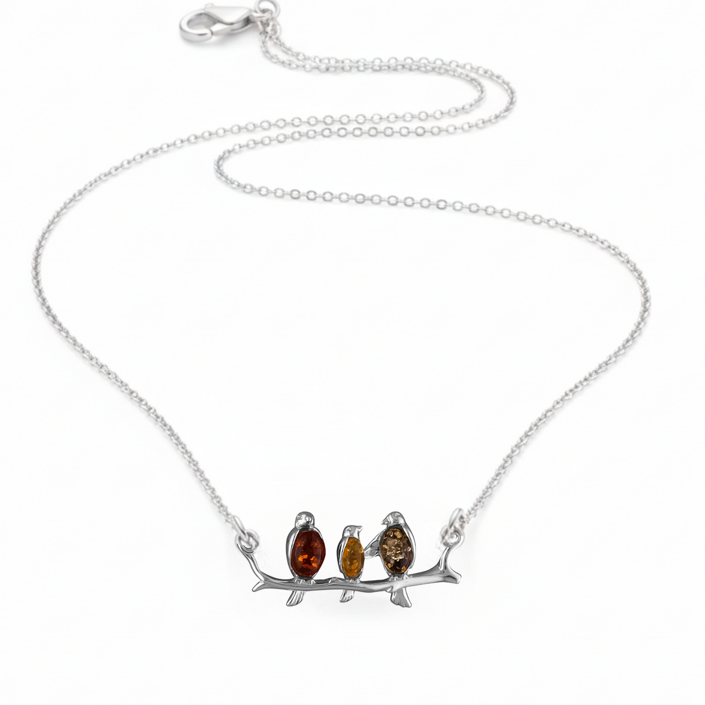 Sterling silver connector necklace showing three birds on a branch. The birds are inlaid with three types of amber - honey, cognac and olive.