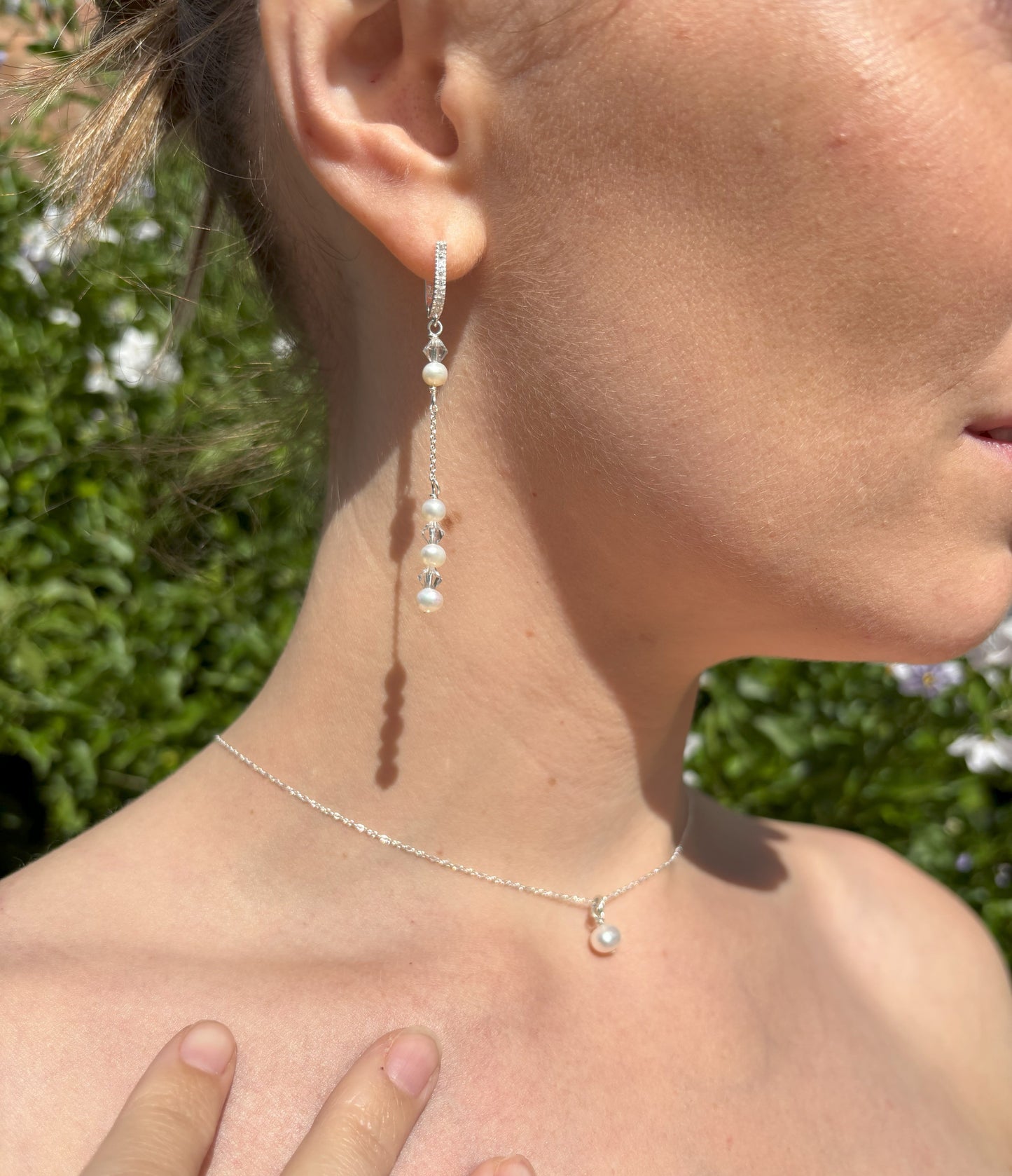 Pearl and crystal earrings using 4mm freshwater pearls and highest quality crystals (also 4mm). The earrings are suspended from sterling silver hoops studded with tiny crystals to reflect the light. Shown worn with our pearl back drop necklace.