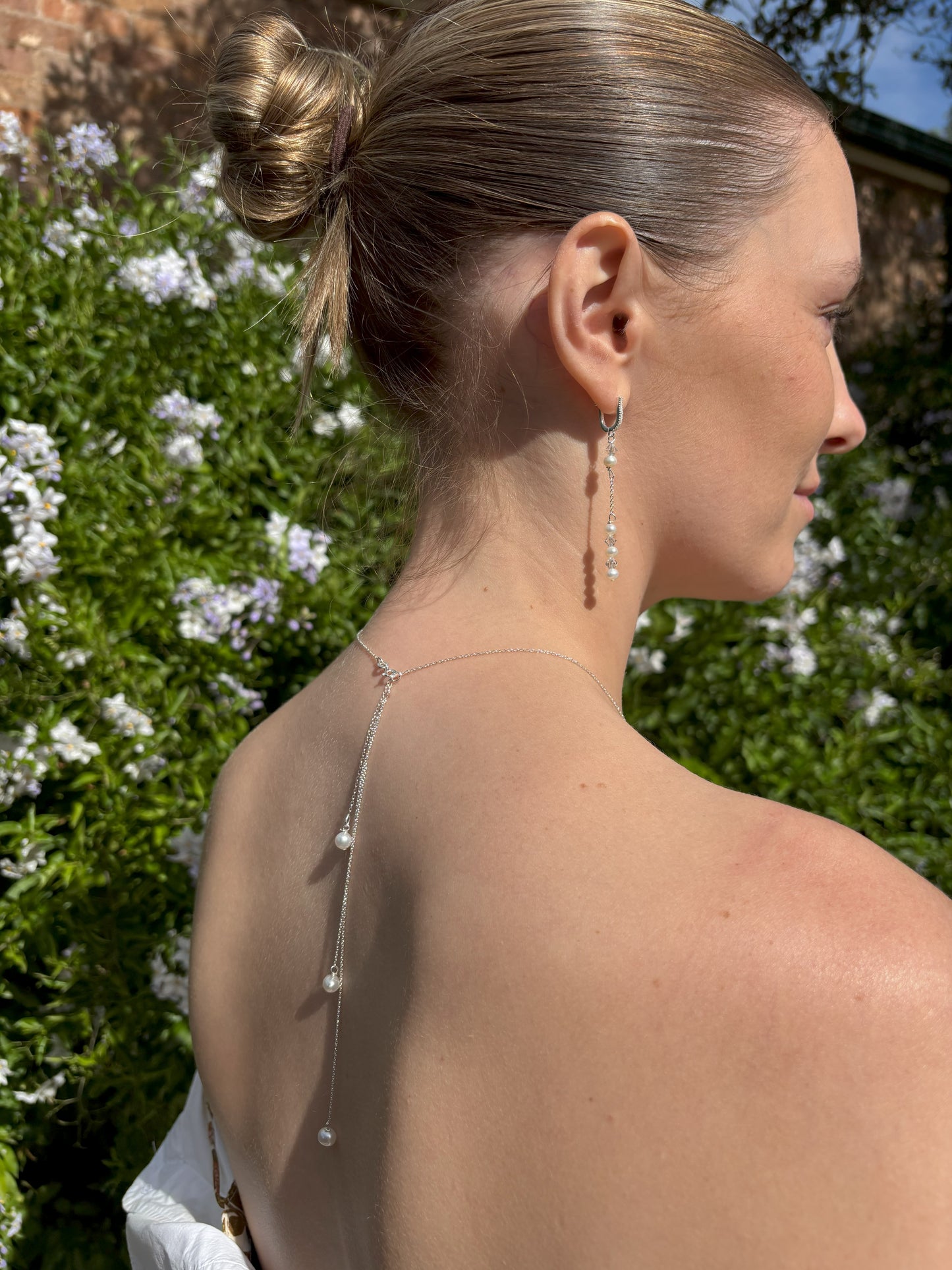 Three freshwater pearls form an elegant back drop feature to this sterling silver bridal necklace. The sterling silver chain is adjustable and the back drop pearls are easily removed for you to wear the necklace in traditional style.