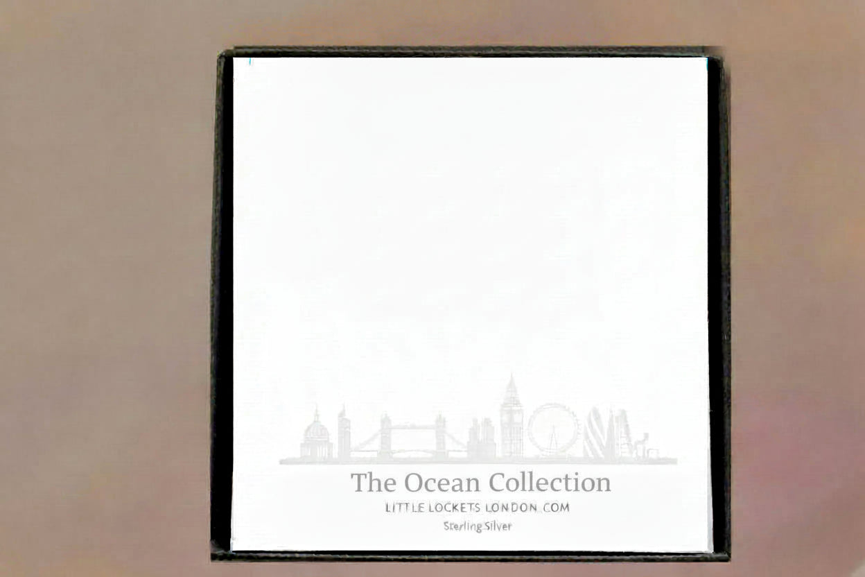 Bracelet is suspended from a card showing the name of the collection and material