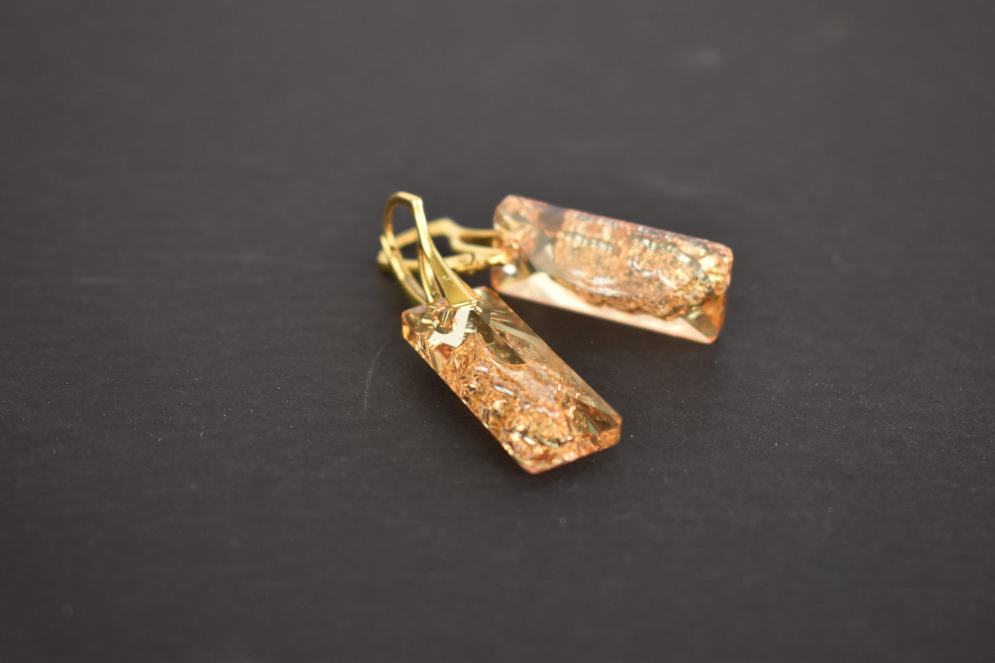 Highest quality Austrian crystal earrings shown in Golden Shadow,. The centre of the crystal is designed to look as if the crystal is still growing and catches the light beaufifully. Suspended from gold plated sterling silver lever back wires and gift boxed
