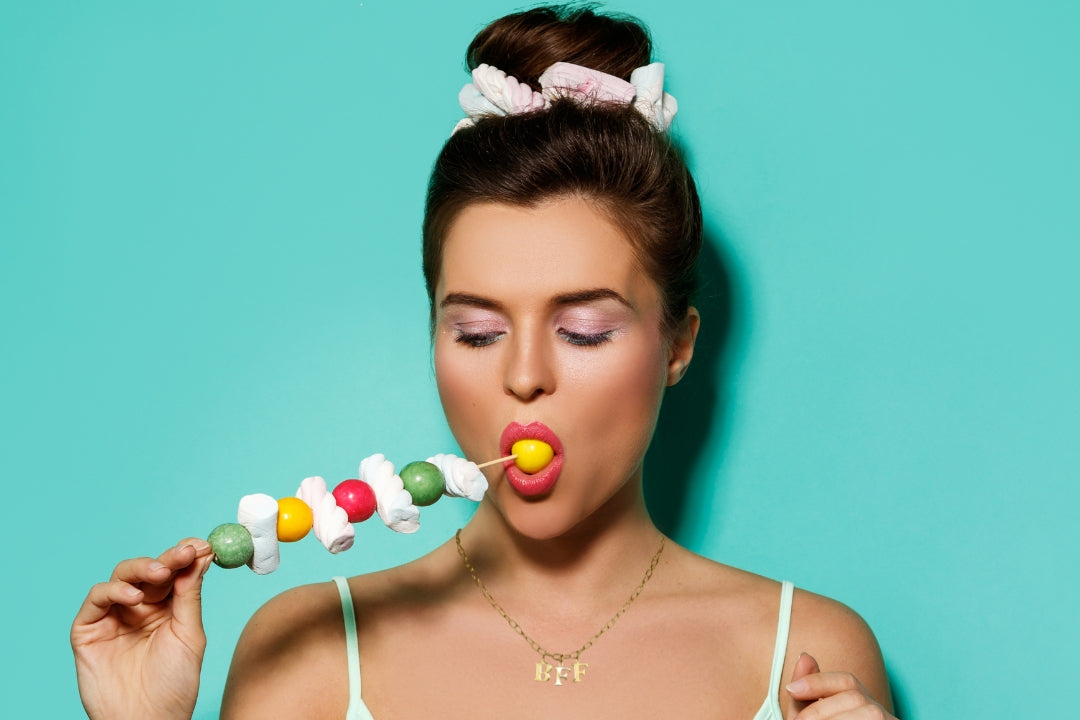 Model wears Necklace chain with and letters. Crafted with a 5.5mm link size chain in gold vermeil with serif letters spelling out BFF (Best Friends Forever). Each letter is a classic serif uppercase font.