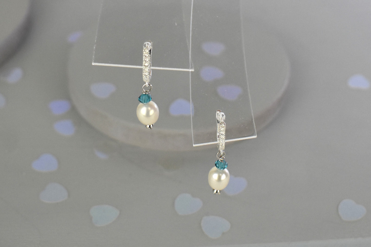 freshwater pearl earrings with aqua Austrian crystals hung from ssterling silver ear wires trimmed with diamante