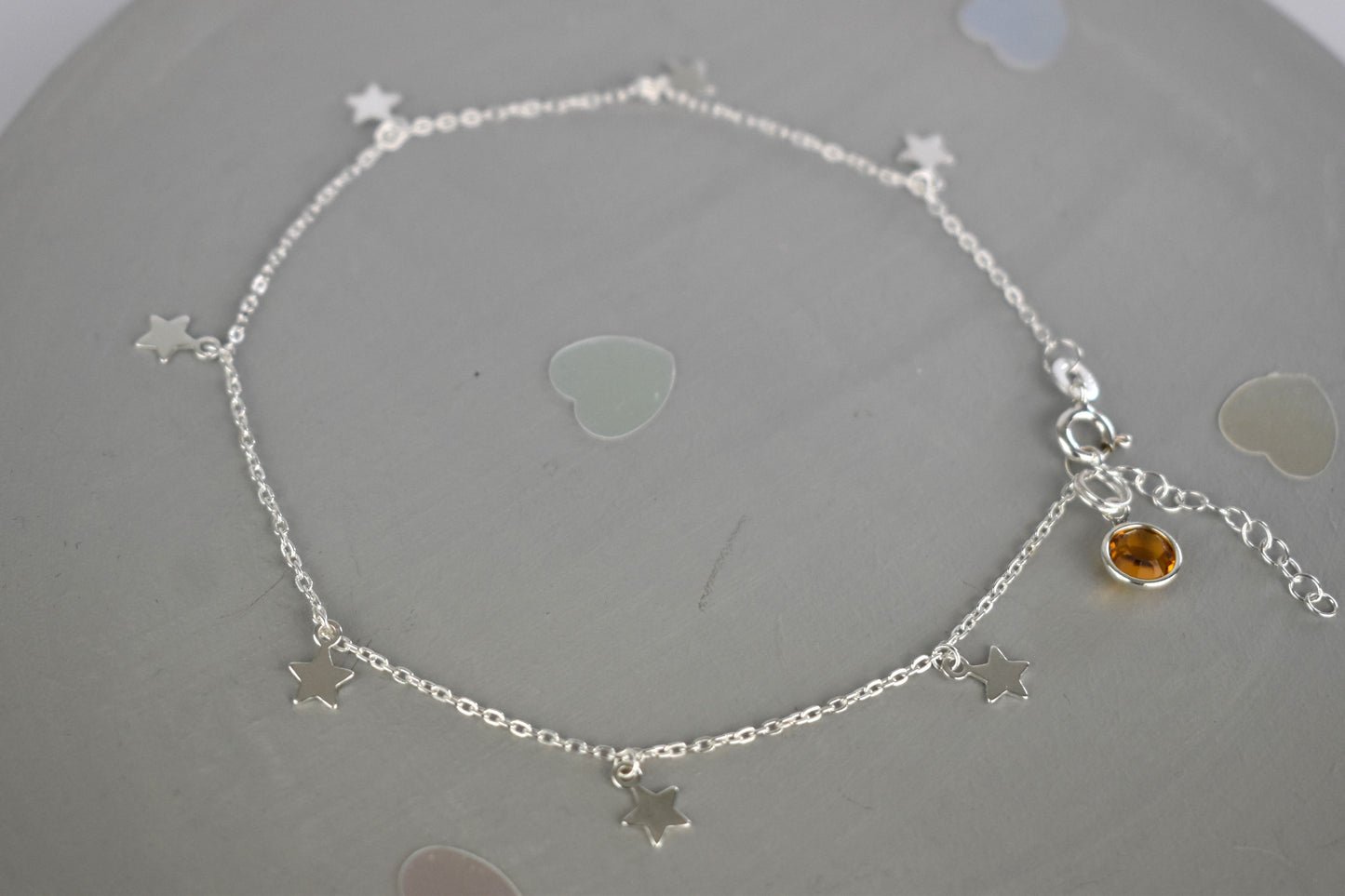 Boho Star Sterling Silver Anklet with Crystal Birthstone Charm. Crafted from sterling silver with flat cable chain links to sit comfortably. A secure fit, thanks to its 9 inch chain and a 1 inch extender.