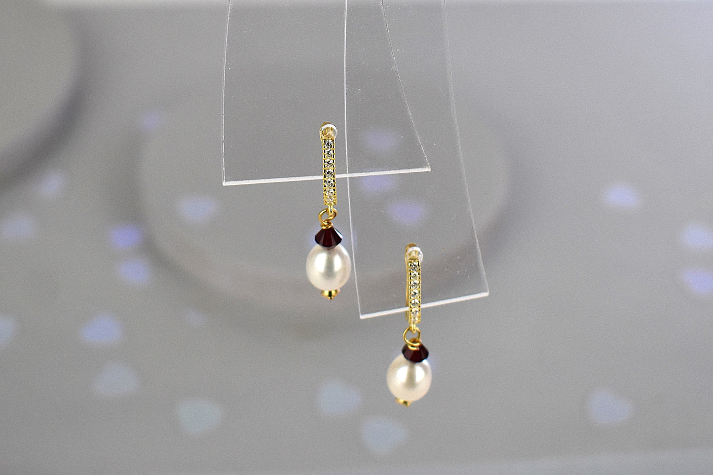 freshwater pearl earrings with sapphire Austrian crystals hung from your choice of sterling silver or gold plated ear wires trimmed with diamante