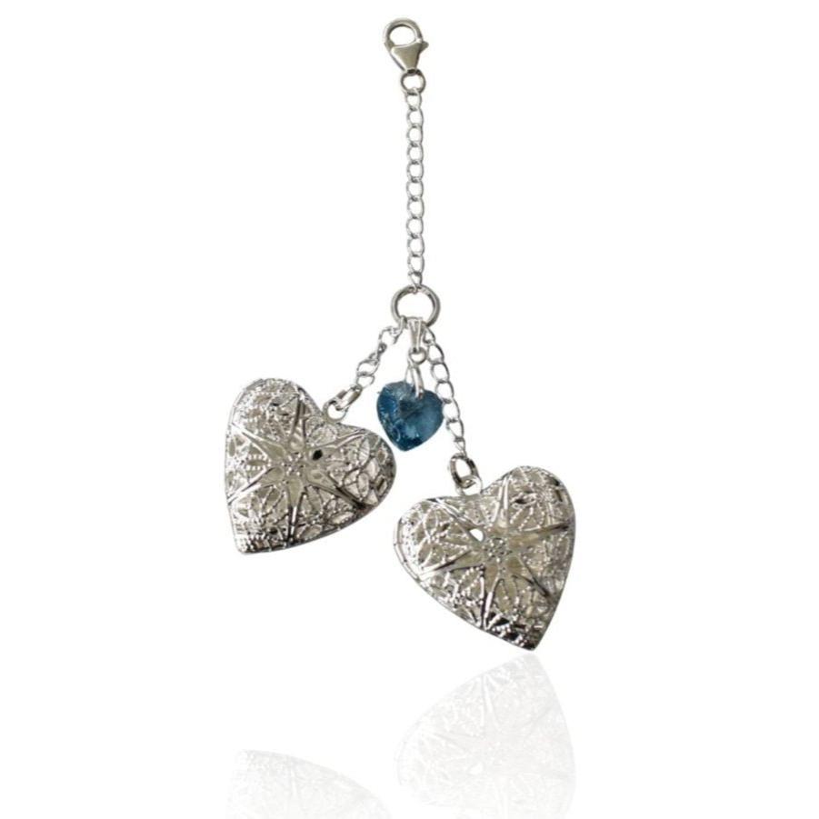 Double filigree bouquet locket. Each locket opens to take one photo. Divided by a crystal blue heart on a sterling silver chain.