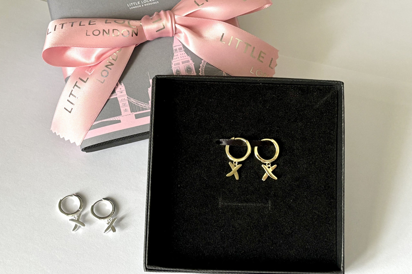 Huggie earrings to match our golden kisses necklace. 9mm huggies gold plated on sterling silver have a "kiss" dangling from each earring.