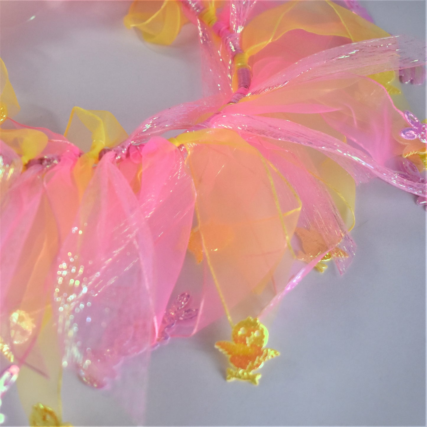 Worn by medium size cockapoo. Fun elastic frill for dogs. Pastel pink and yellow tulle frills with foil pink rabbits and yellow chicks on the end of each tulle frill. One size.