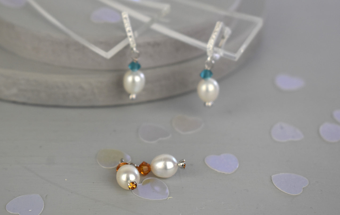freshwater pearl earrings with amber Austrian crystals hung from your choice of sterling silver or gold platedear wires trimmed with diamante