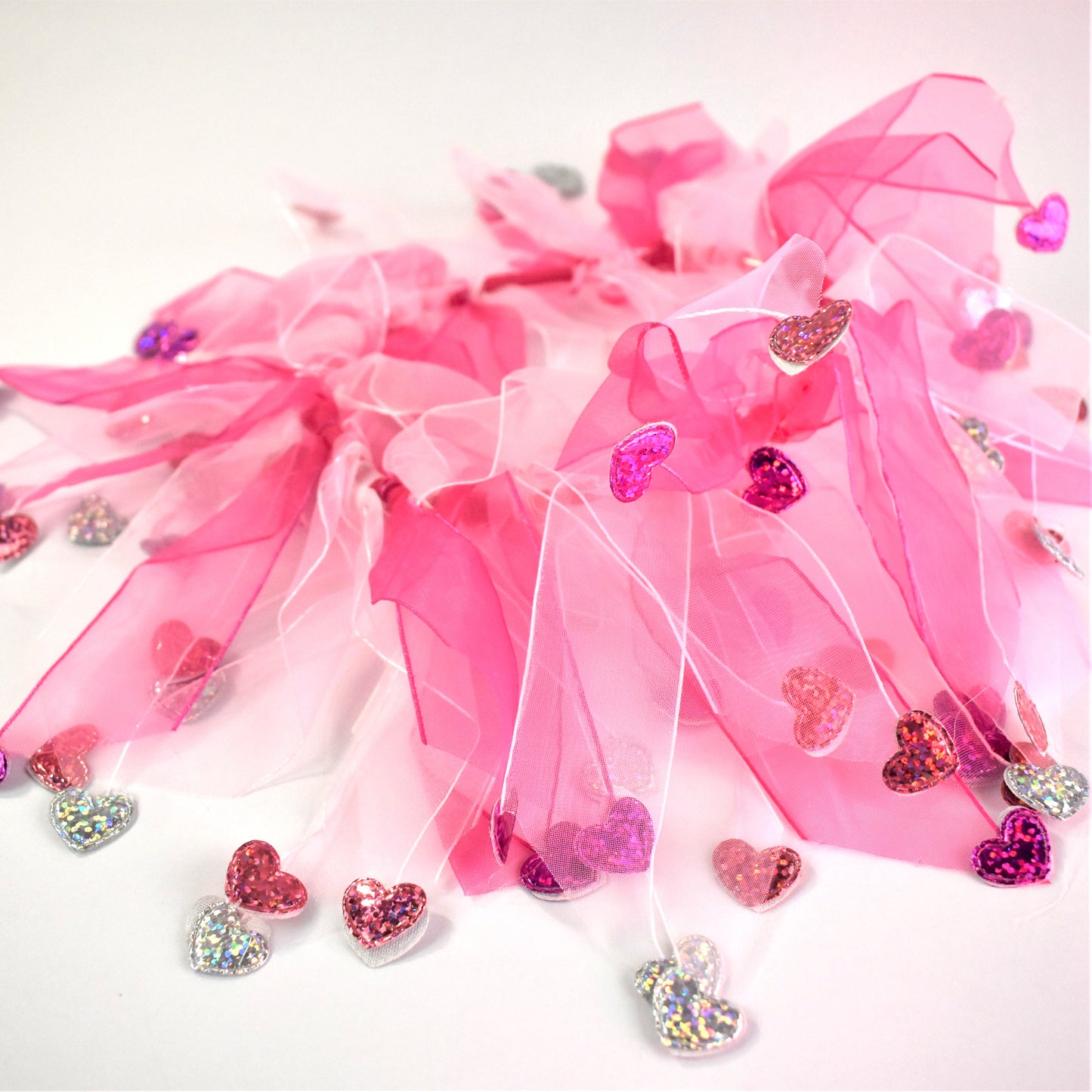 Elasticated love heart frill collar adds a touch of charm to your dog's look. Made from high-quality materials, this playful collar features a stylish love heart design and a decorative frill made of white and pink tulle ribbons. One size shown on Cockapoo model. Worn on its own or easily slipped on top of collar