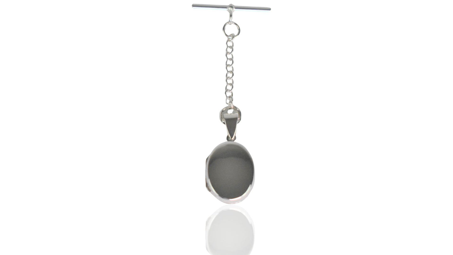 Sterling Silver contemporary Men's Oval Photo Locket. The locket is oval design, can hang from a lapel, inside a jacket pocket, or alongside a buttonhole. Holds up to two photos. Choose between a t-bar or spring clasp.