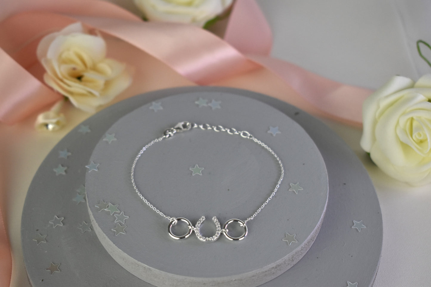 Sterling silver bracelet with cubic zircona horseshoe link. Adjustable by 1 inch extender.
