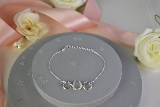 Sterling silver bracelet with cubic zircona horseshoe link. Adjustable by 1 inch extender.