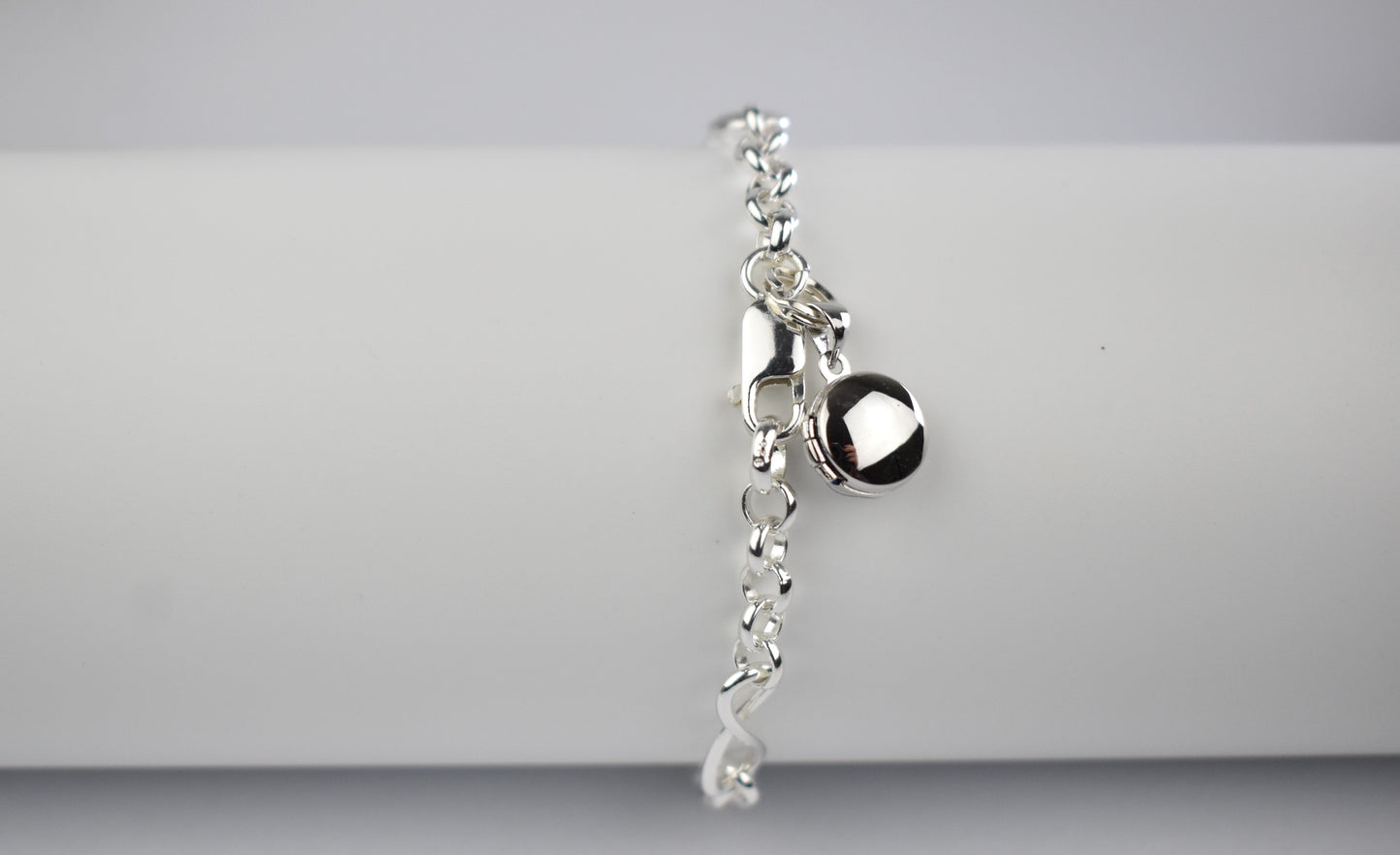 Sterling silver infinity bracelet with miniature round photo locket