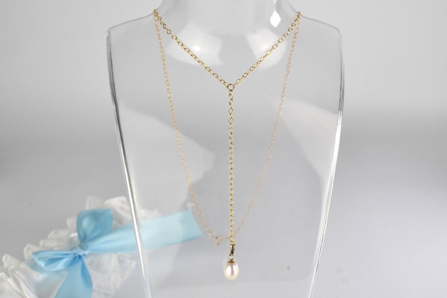 Gold plated laria necklace shown with AAA quality freshwater pearl drop.