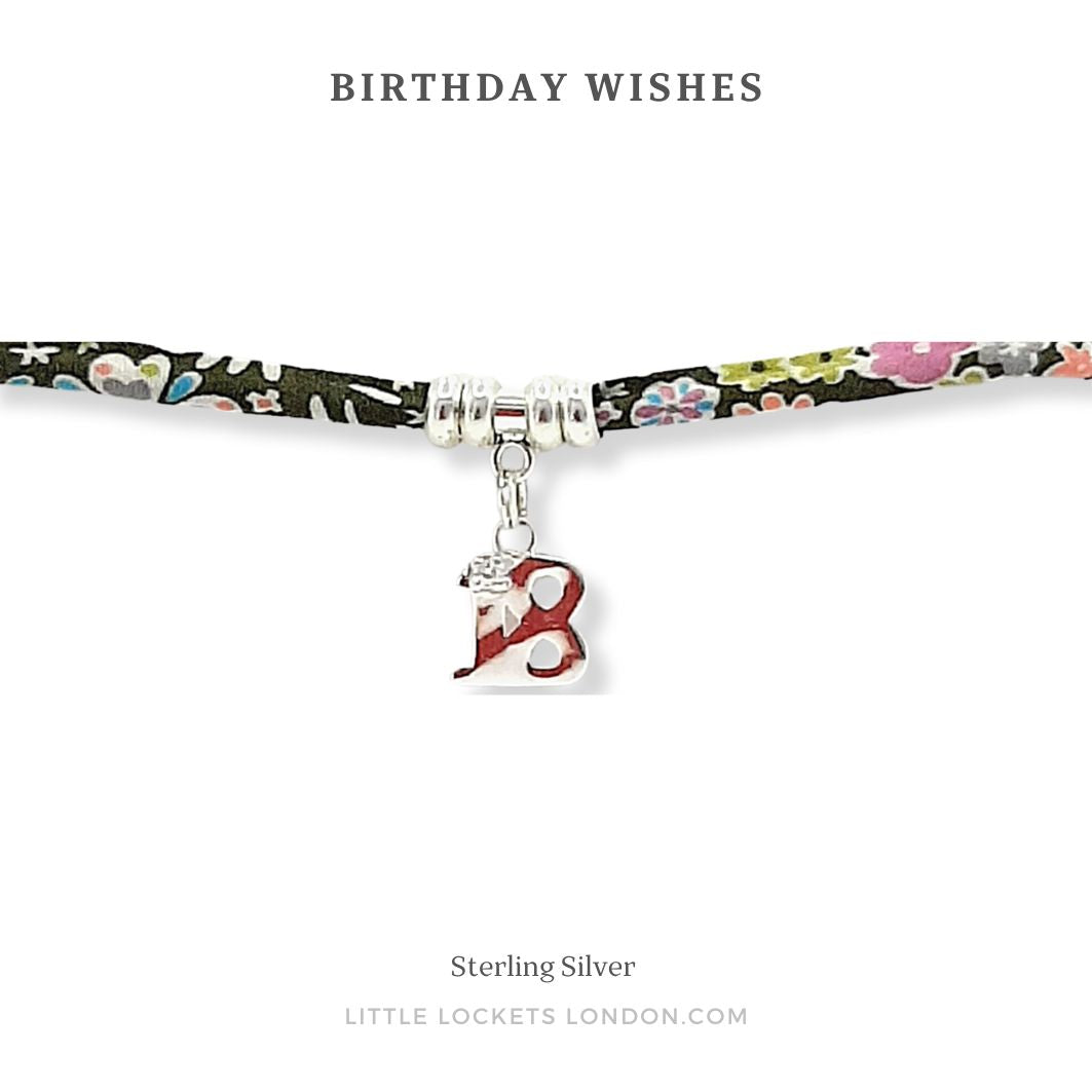 Liberty print adjustable bracelet with sterling silver beads and 18 charm, shown on card with the message "Birthday Wishes"