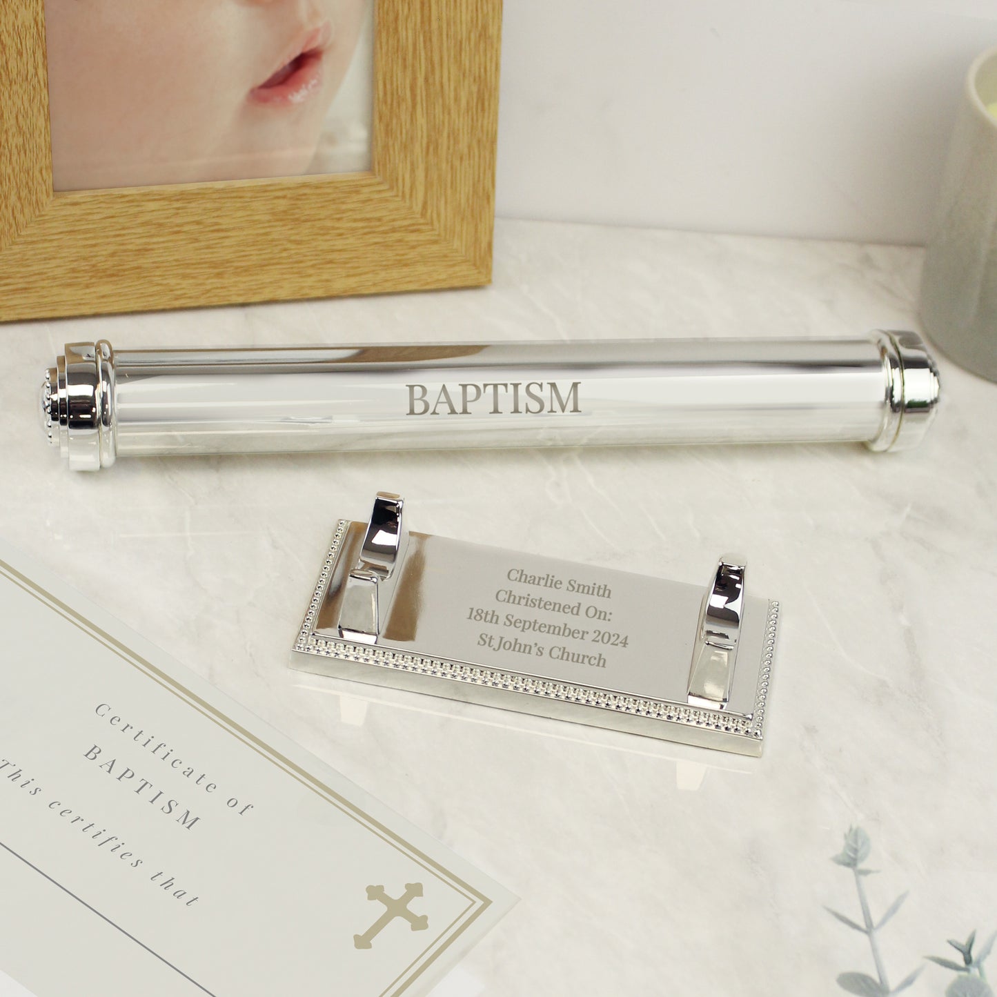 Silver plated certificate holder on a silver plated base shown as containing a baptism cettificate for a baby and engraved withtheir name and christening details