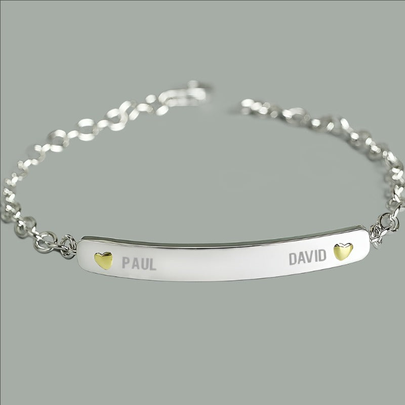 sterling silver bracelet engraved with two names and a tiny gold plated heart beside each