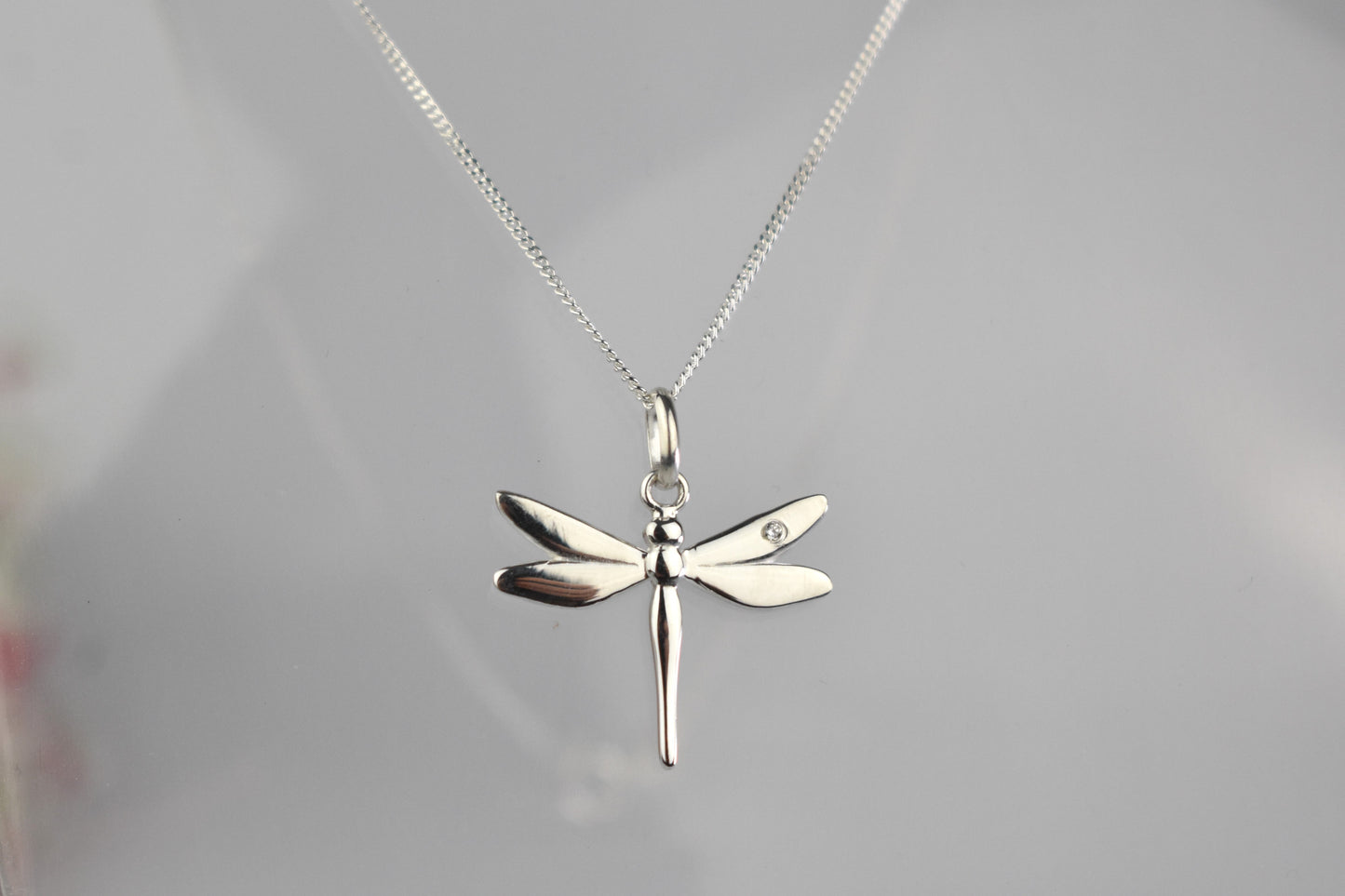 Dragonfly is sterling silver with a sparkling cubic zirconia crystal on its wing.