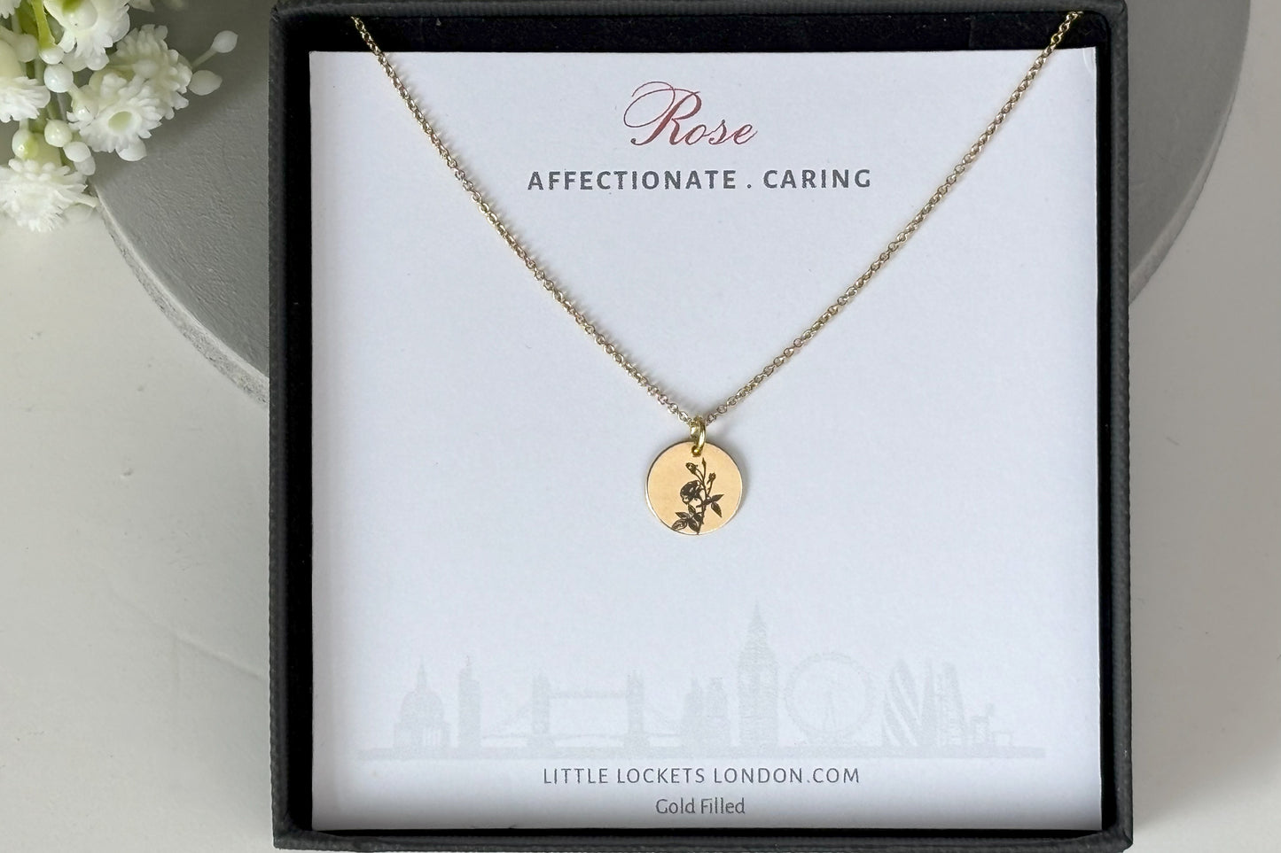 delicate Gold Filled Birth Flower Pendant. Crafted on an 11mm coin pendant, this simple piece is engraved with the intricate design of birth flowers on the front side and on the reverse side features a hidden personalised engraving, making it truly unique.