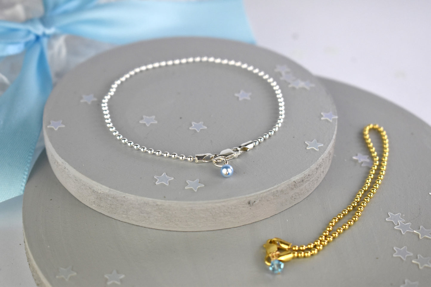 Something Blue Ball Bracelet shown in sterling silver and sterling silver with 14K gold plate finishes. The sterling silver bracelet has the blue pearl and the gold finish has the blue crystal.