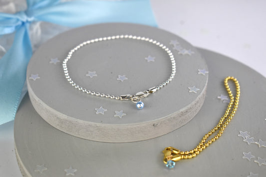 Something Blue Ball Bracelet shown in sterling silver and sterling silver with 14K gold plate finishes. The sterling silver bracelet  has the blue pearl and the gold finish has the blue crystal.