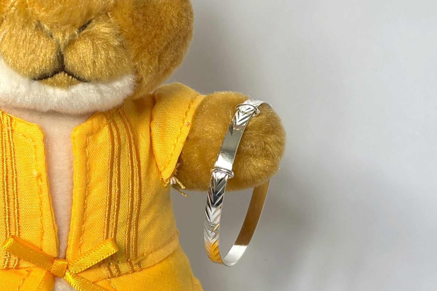 sterling silver expandable baby bracelet features a delicate diamond-cut chevron pattern