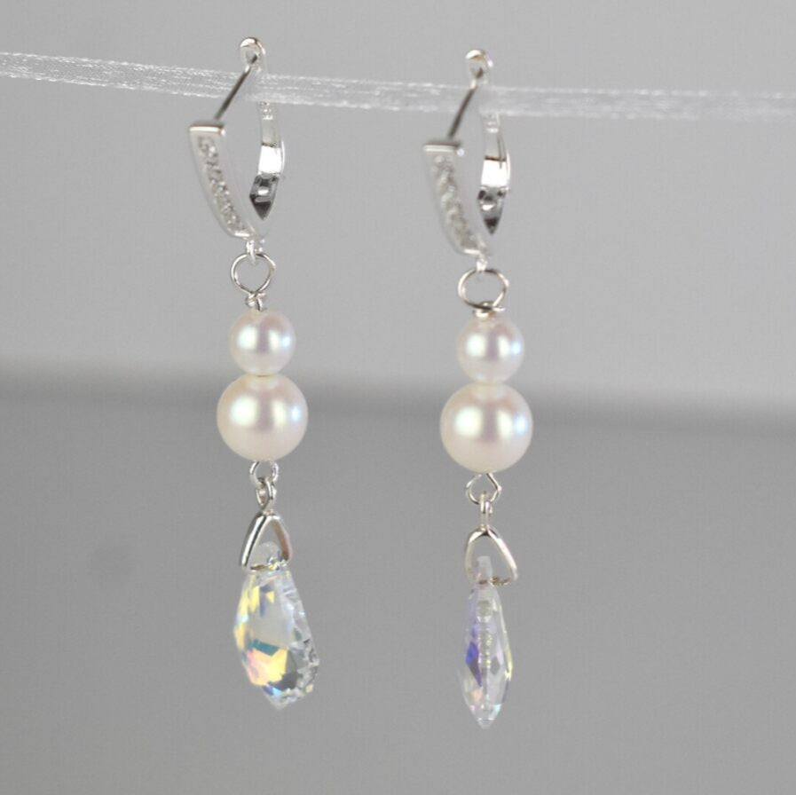 To match your Baroque back drop necklace, these Baroque crystal and freshwater pearl earrings. the highest quality crystal is suspended from a sterling silver bail and topped with two freshwater pearls. The earrings are sterling silver hoops with a crystal inlay.
