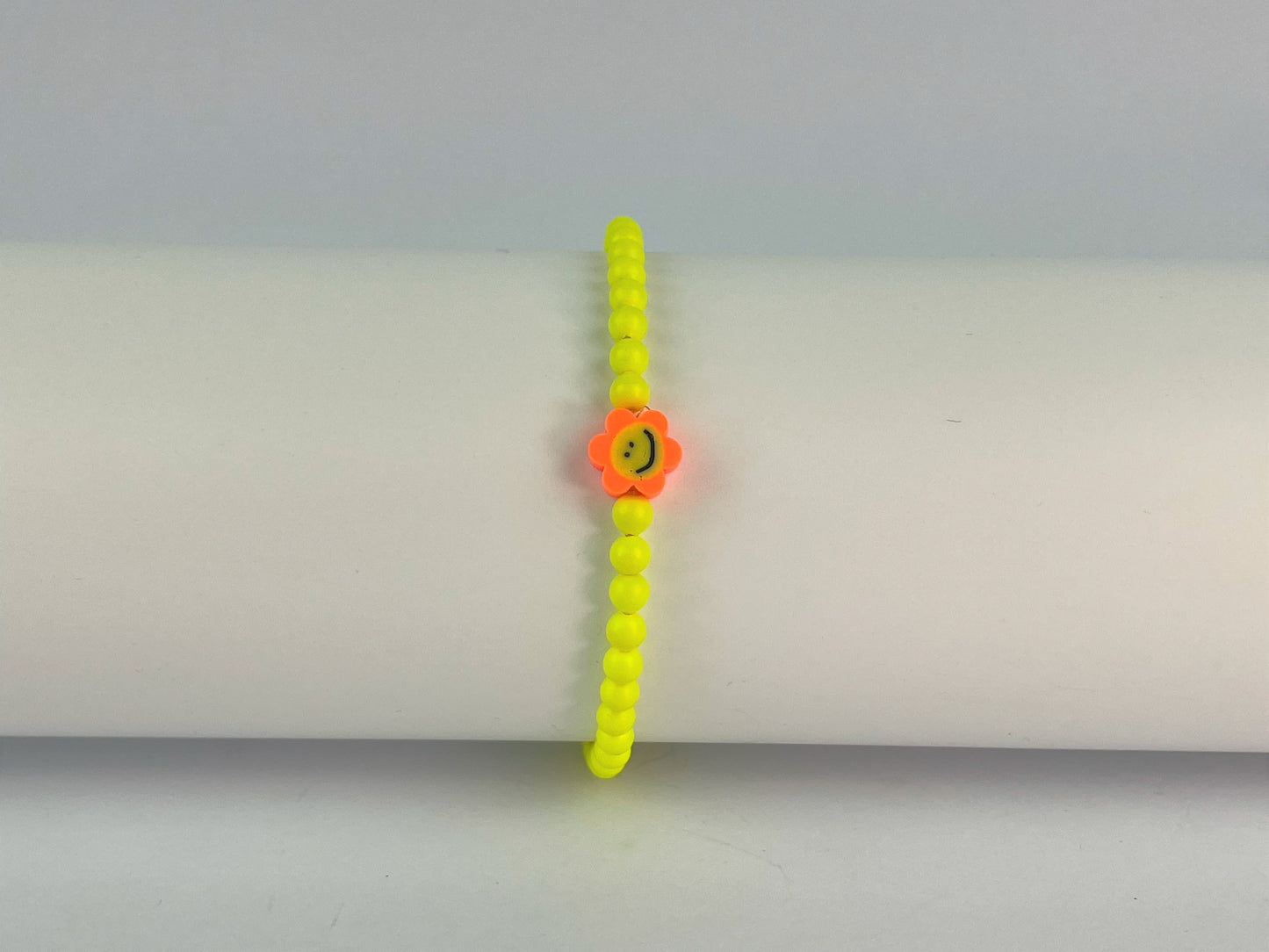 yellow neon beads with orange flower smiley face