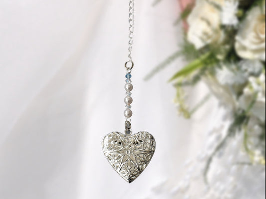 A pretty silver filigree locket is suspended from a row of high quality glass pearls and crystals and finished with a tiny something blue bead. A chain and lobster clasp makes it easy to fasten to your wedding bouquet