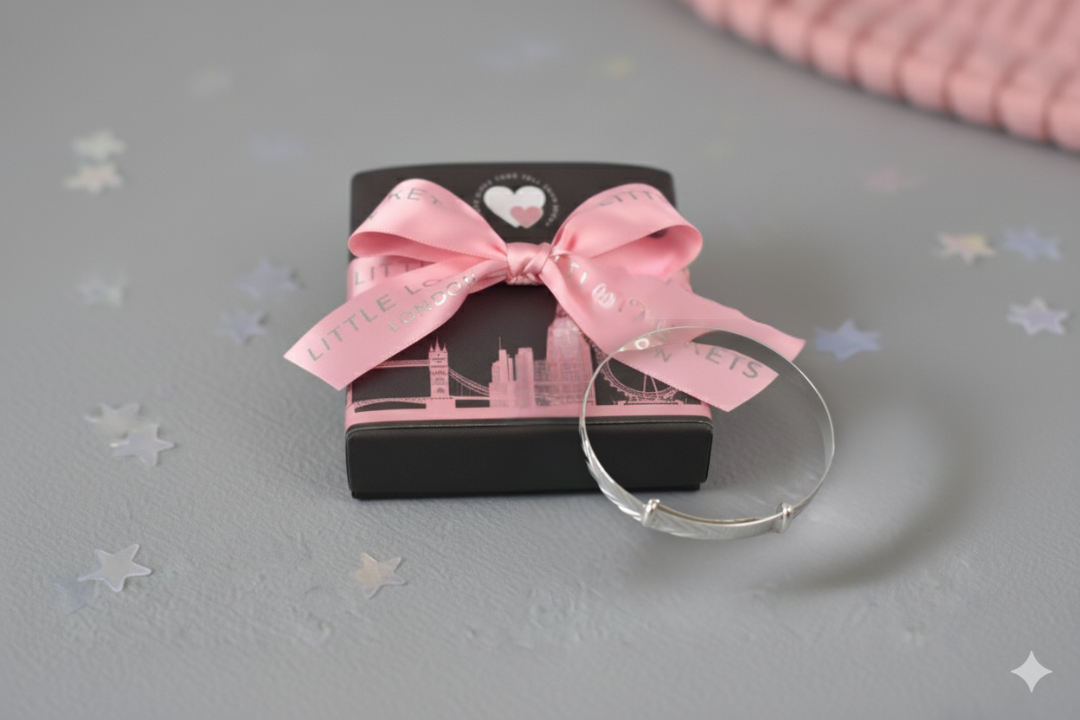 sterling silver expandable baby bracelet features a delicate diamond-cut chevron pattern