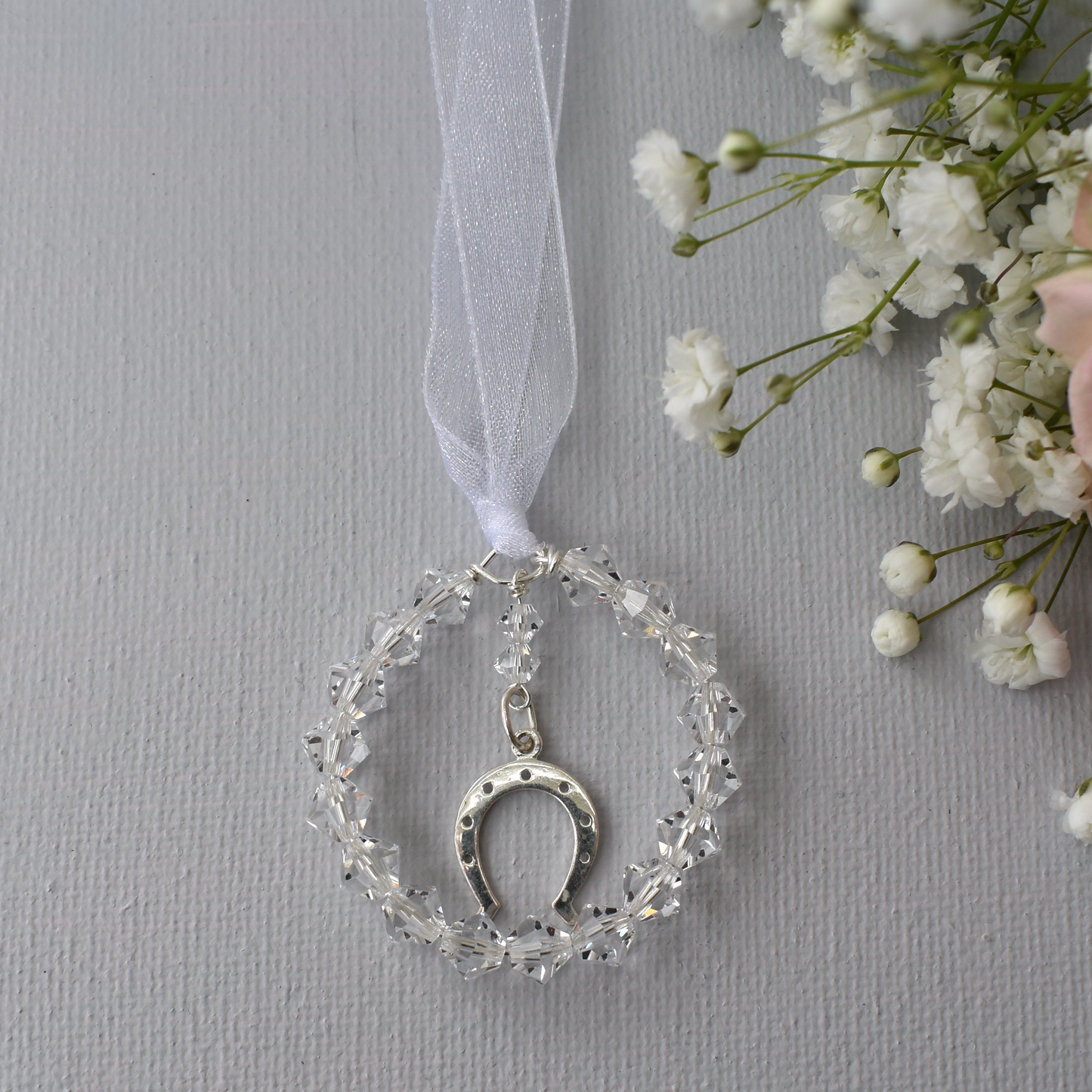 The horseshoe bouquet charm. Sterling silver horseshoe charm surrounded by a circle fo high quality Austrian crystals.