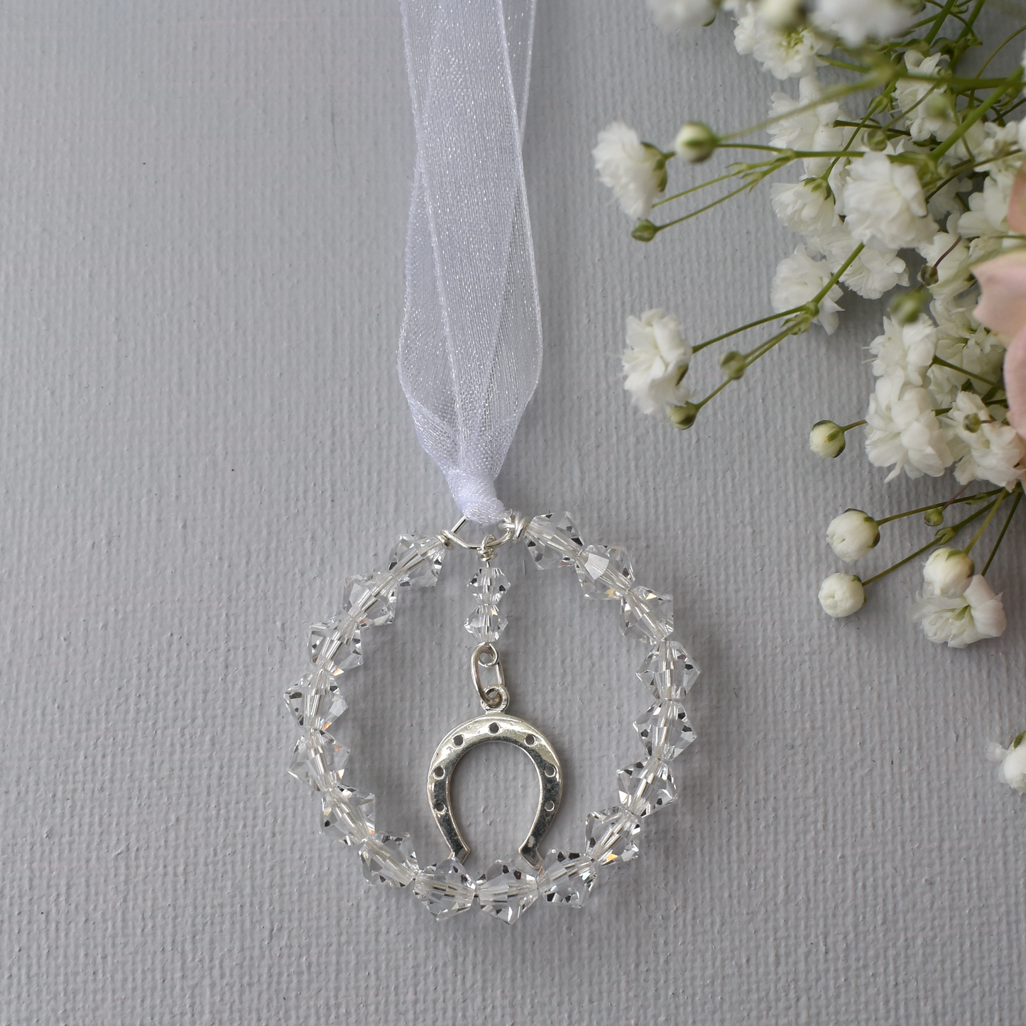 The horseshoe bouquet charm. Sterling silver horseshoe charm surrounded by a circle fo high quality Austrian crystals. 