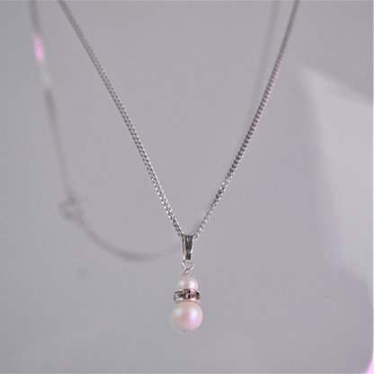 close up of double pearl pendant