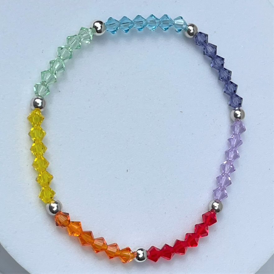 Multicolour rainbow crystal stacking bracelet made up of 4mm high quality crystals interspersed with a silver plated bead. Elasticated for comfort.