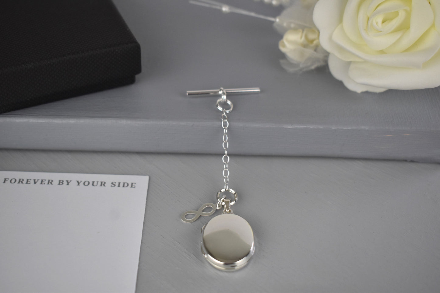 Sterling Silver Men's Photo Locket with a sterling silver Infinity charm. The Infinity charm makes a beautiful statement meaning everlasting, eternal and never-ending. The locket can hold up to two photographs.