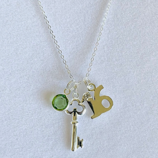 Pretty 16th birthday charm with a key pendant and birthstone