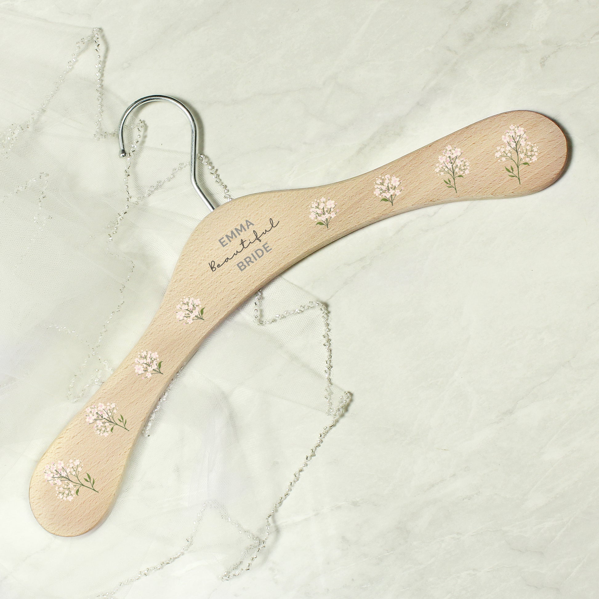 PERSONALISED wooden wedding hanger with three lines of text and flowers along the arms of the hanger