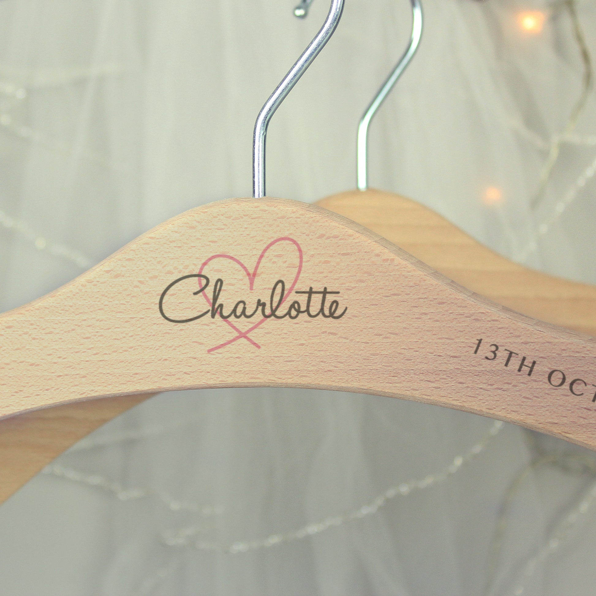 Perfect for identifying and keeping safe those special dresses. The wooden personalised wedding hanger has a pretty heart design with room for three lines of text across the hanger.