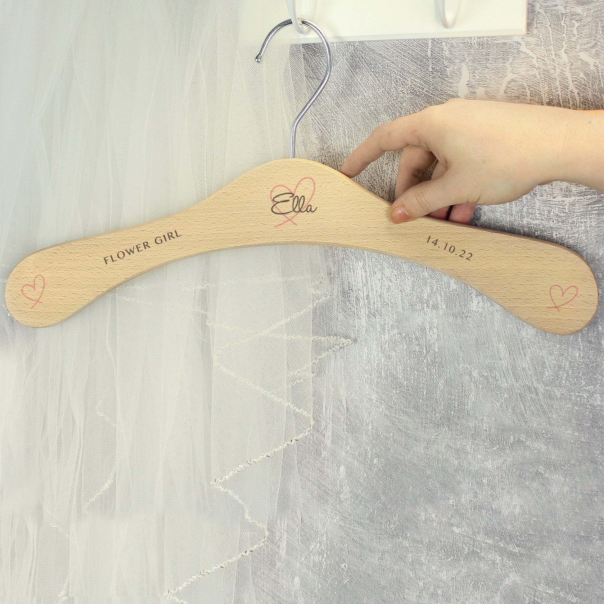 Perfect for identifying and keeping safe those special dresses. The wooden personalised wedding hanger has a pretty heart design with room for three lines of text across the hanger.