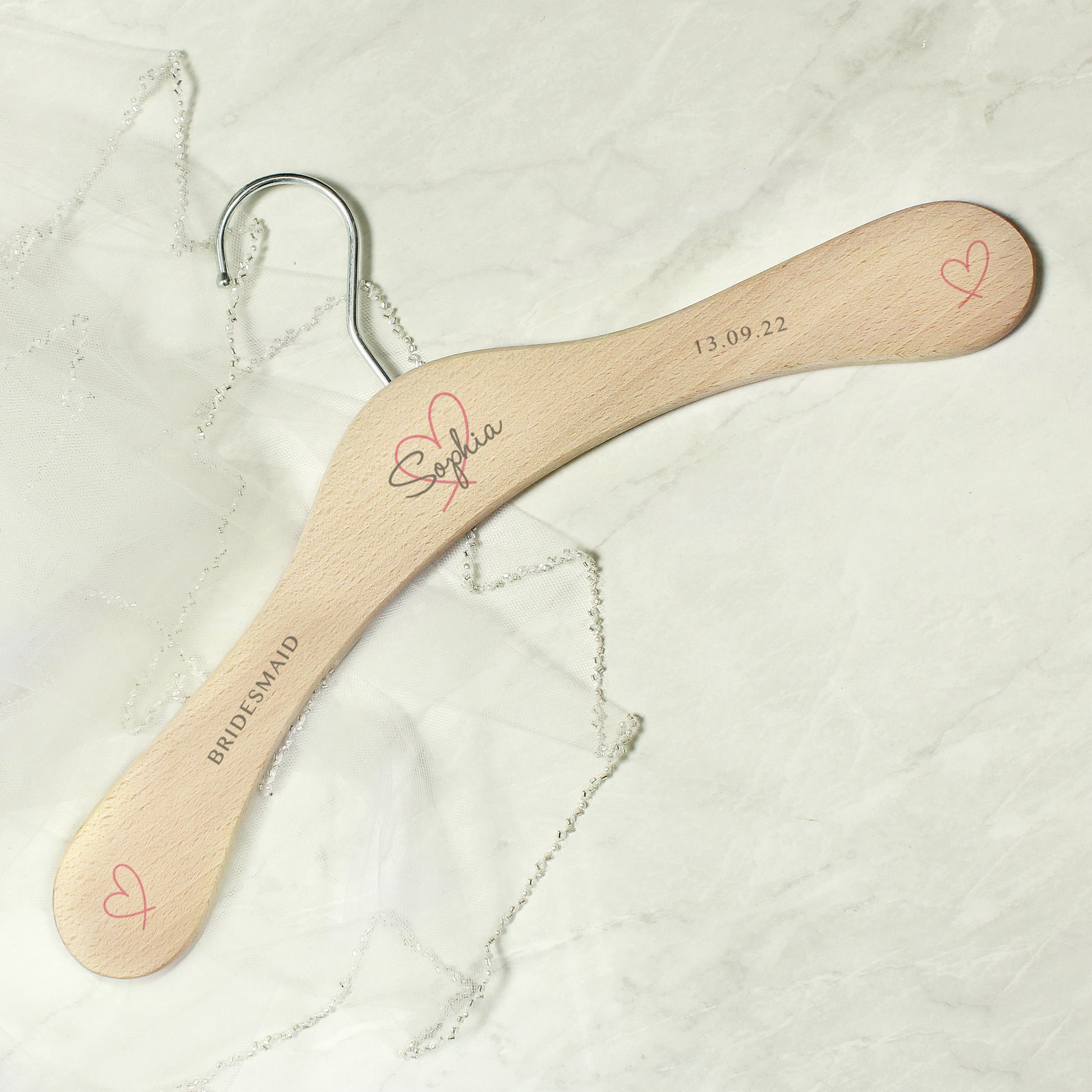 Perfect for identifying and keeping safe those special dresses. The wooden personalised wedding hanger has a pretty heart design with room for three lines of text across the hanger.