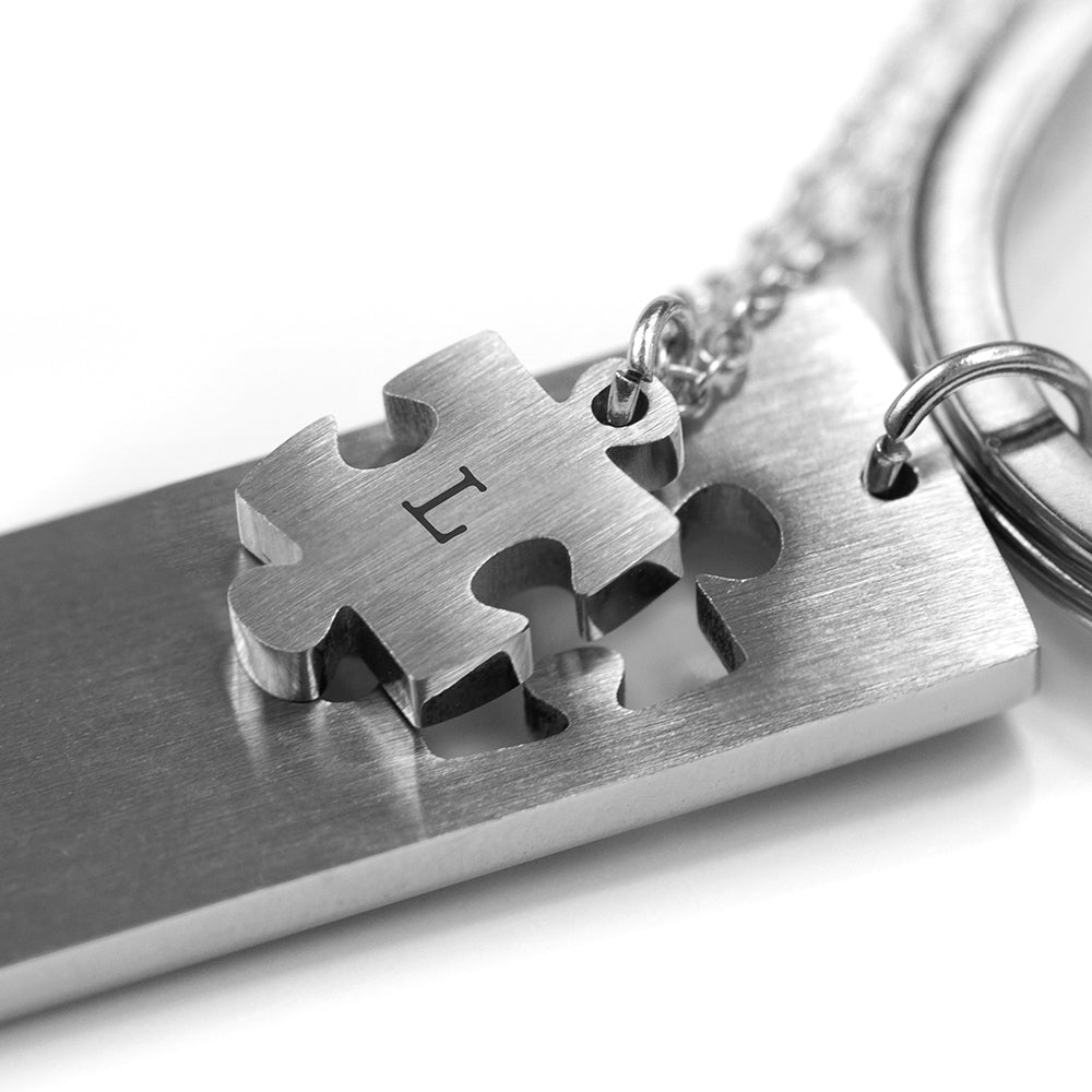 Perfect fit puzzle and keyring. The keyring has a missing jigsaw piece. The missing piece is on a pendant. Add a message to the keyring and an initial to the pendant.