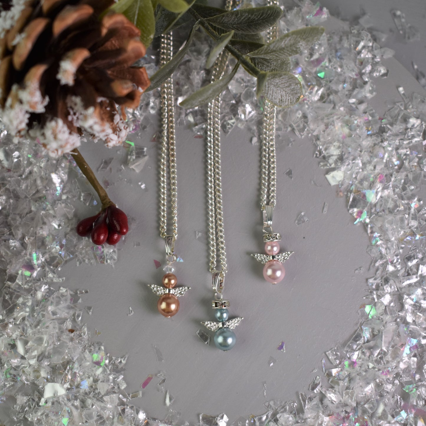 snow angel earrings shown in various pearl colours