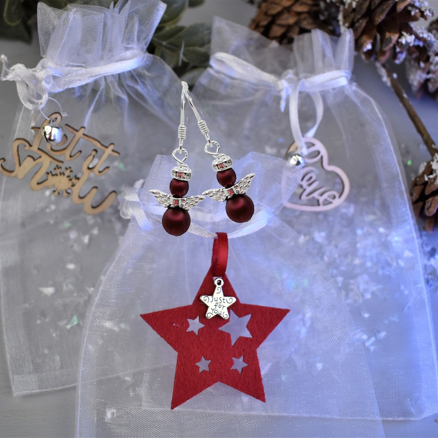 snow angel earrings shown in burgundy pearl with sterling silver wires