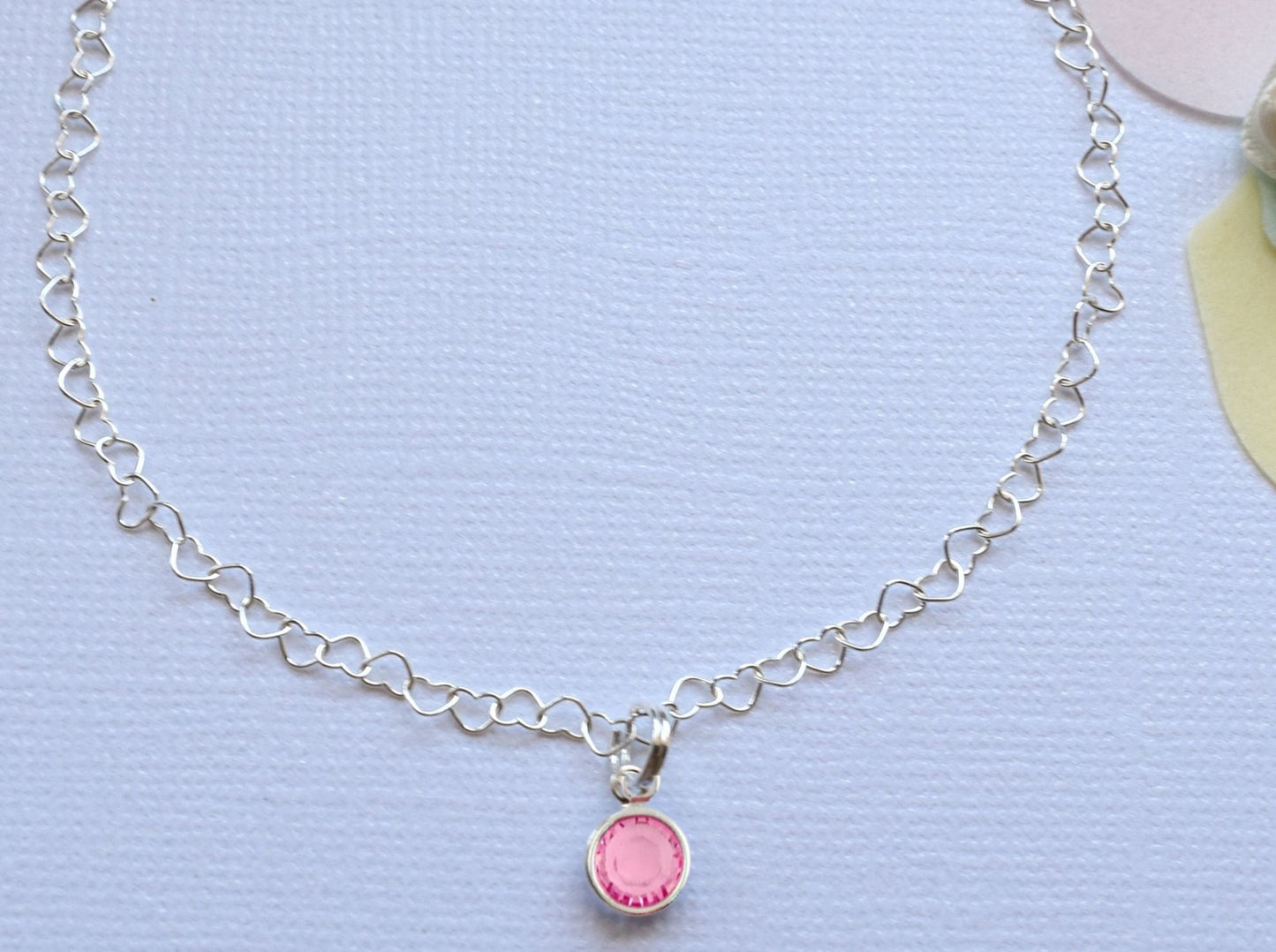 beautiful anklet with heart shaped lines and adorned with a single birthstone of your choice. Sterling silver.