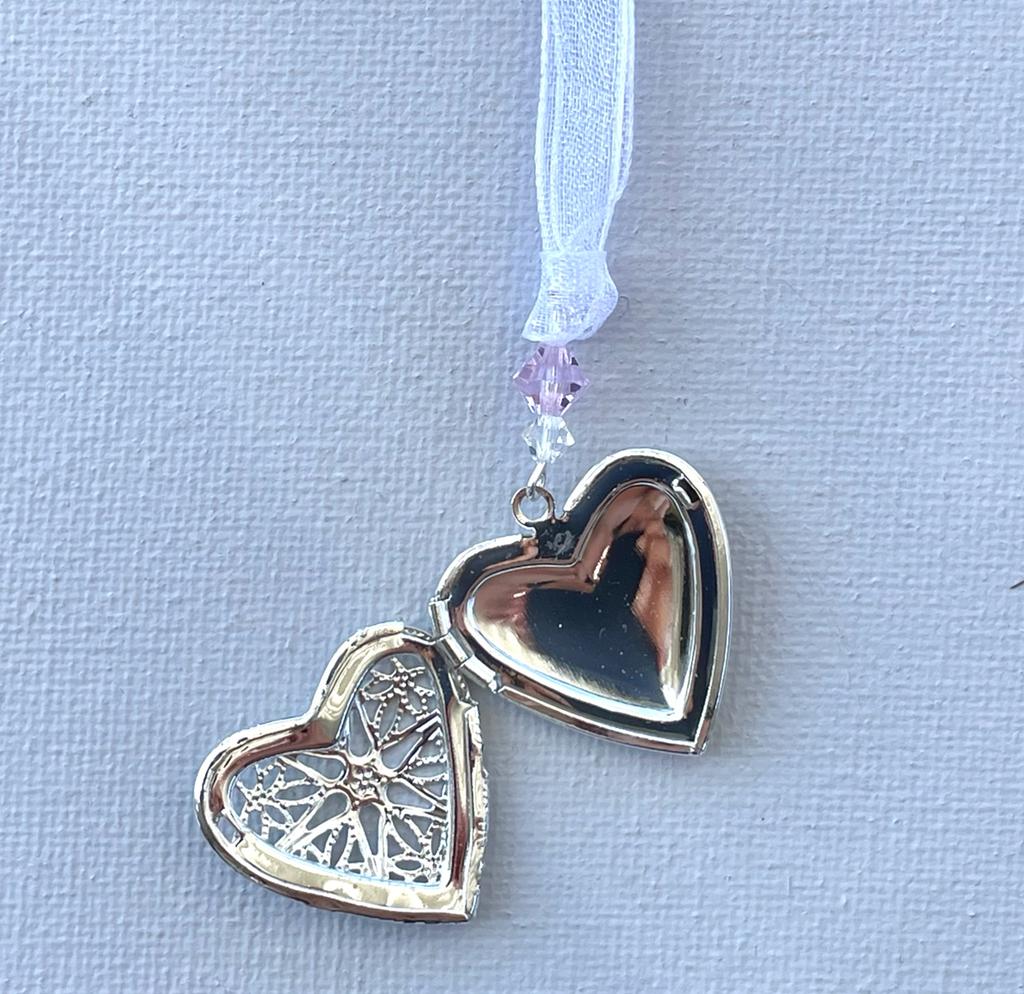 Wedding party locket for use in the bridesmaids bouquet or in a corsage. Filigree heart with the highest quality crystal bead in the wedding colours and fastened with organza ribbon., shown open and finished with pink crystal bead