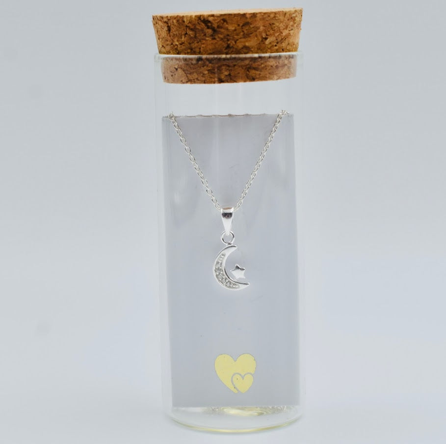 sterling silver crescent moon with cubic zircona and tiny star on a sterling silver chain in a glass bottle with cork top. Little Lockets London Message In a Bottle range