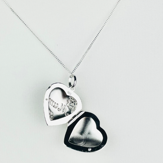 Sterling silver heart shaped locket engraved with the word "Mum" in script and flower decoration. Suspended from a sterling silver chain open view