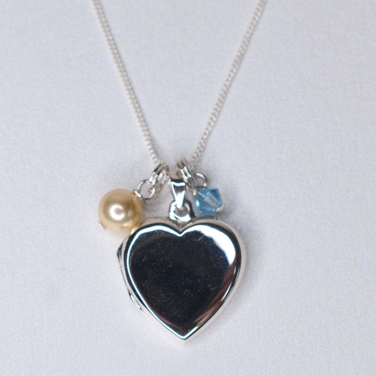 Sterling silver heart locket with cream  pearl and blue crystal